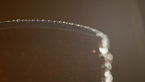 Close-Up-Backlit-Shot-Of-Condensation-Droplets-On-Revolving-Takeaway-Can-Of-Cold-Beer-Or-Soft-Drink